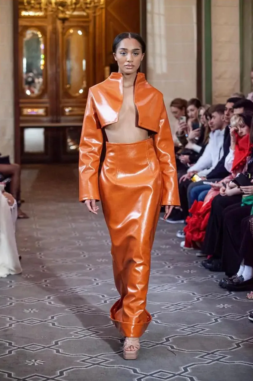 AltheaMink orange look on the runway, as featured by Cosmopolitan